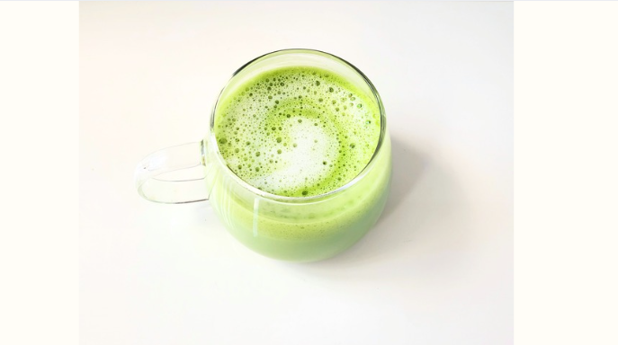 Premium matcha latte in a glass cup representing calm focus and balanced energy