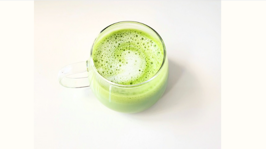 Premium matcha latte in a glass cup representing calm focus and balanced energy
