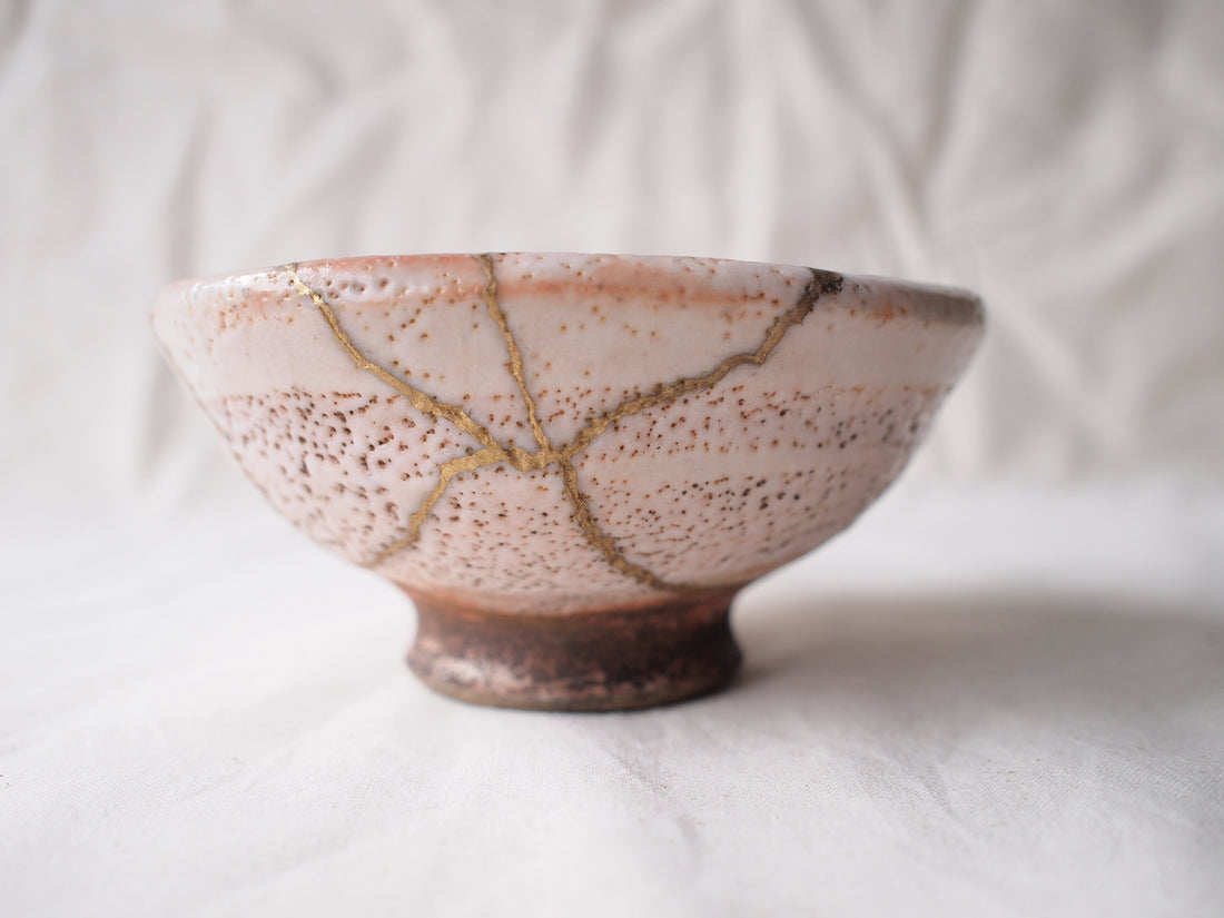 matcha in a handmade bowl showing natural texture and imperfect foam in soft light