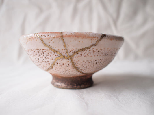 matcha in a handmade bowl showing natural texture and imperfect foam in soft light