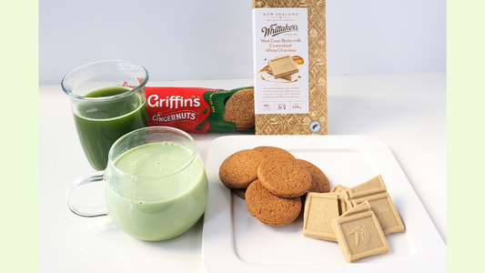 cups of matcha served with Ginger Nut biscuits and Whittaker's White Chocolate.